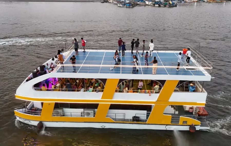 Two-deck party boat on a Goa river seen from above