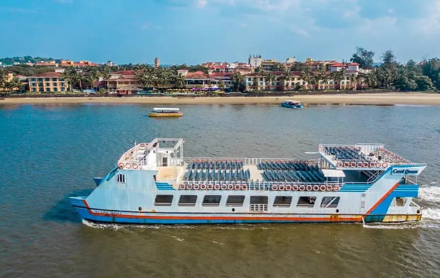 Cruise boat on the Mandovi river with the Panaji waterfront behind