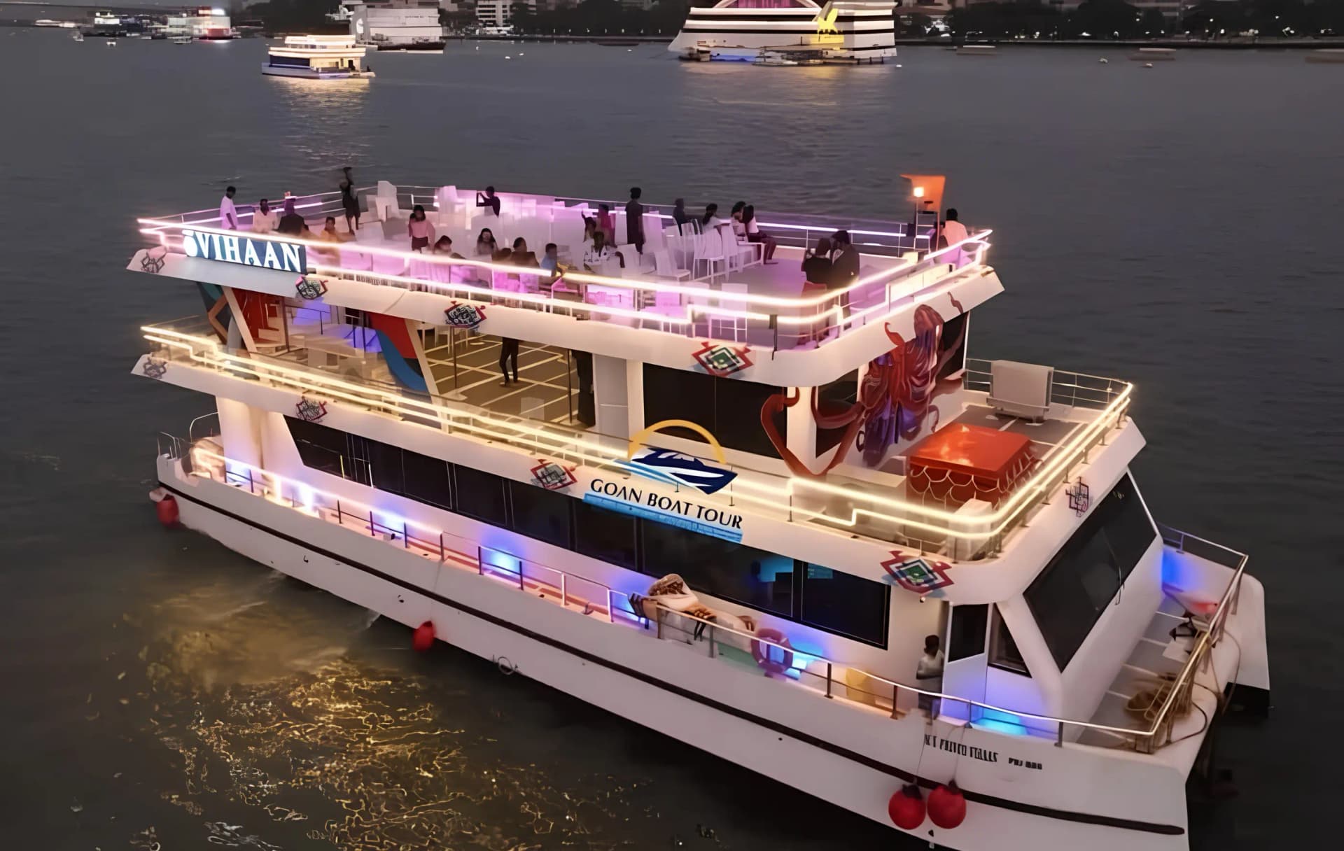 Lit-up dinner cruise boat on the Mandovi river in Goa at dusk